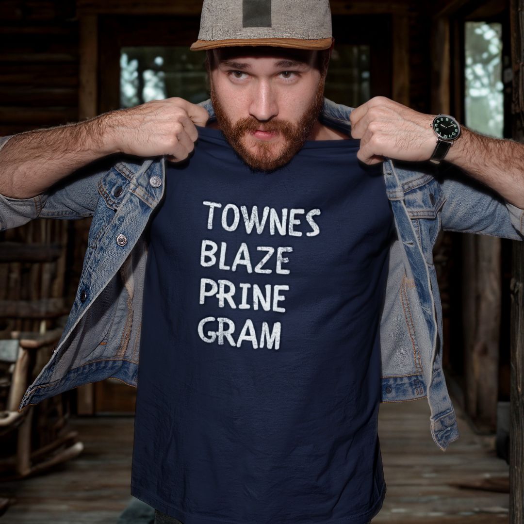 Man wearing a navy blue t-shirt with text in a rustic setting
