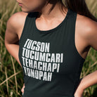 Woman wearing Outlaw music graphic black racerback tank top
